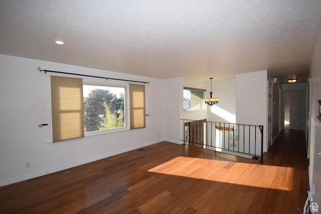 9111 S Parakeet Dr, Sandy, UT 84093 - unfurnished room featuring baseboards, a notable chandelier, a textured ceiling, recessed lighting, and wood finished floors