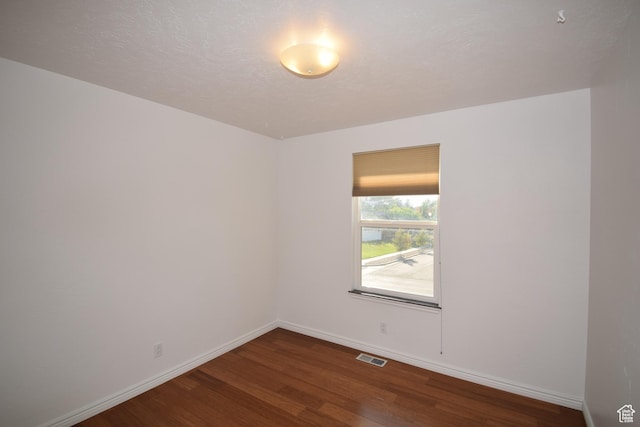 9111 S Parakeet Dr, Sandy, UT 84093 - unfurnished room featuring dark wood-style flooring, baseboards, and visible vents