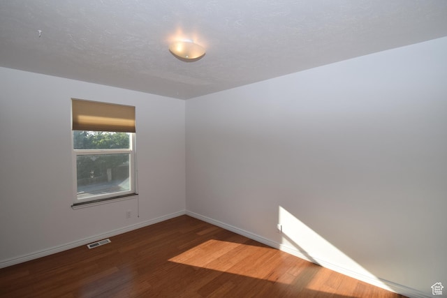 9111 S Parakeet Dr, Sandy, UT 84093 - unfurnished room with visible vents, baseboards, and wood finished floors