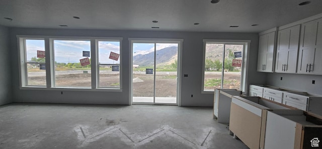 doorway to outside featuring a mountain view and concrete flooring