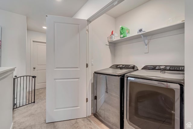 clothes washing area with laundry area and washer and clothes dryer