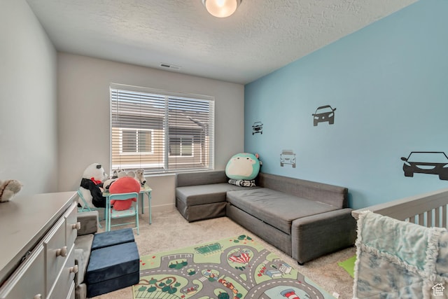 living area featuring carpet flooring, visible vents, and a textured ceiling