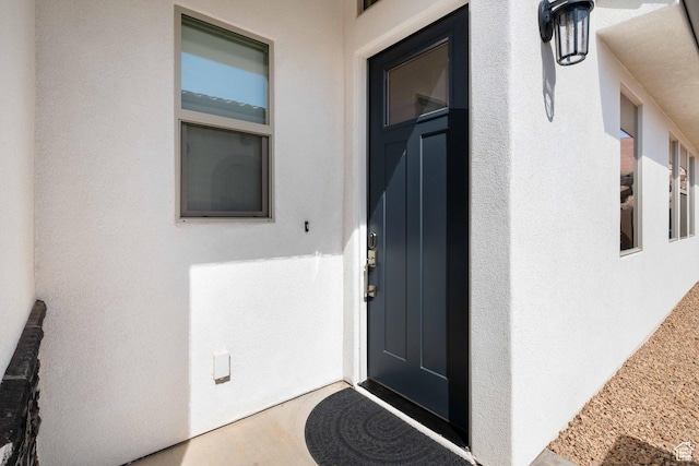 entrance to property with stucco siding