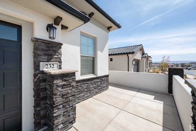 view of patio featuring a balcony