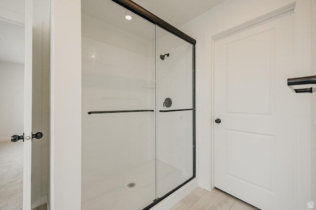 full bath featuring a shower stall and tile patterned floors