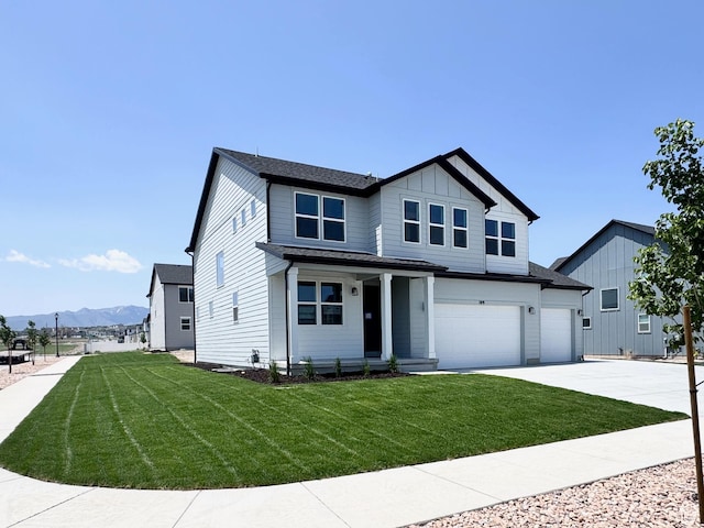 109 N Blue Mountain Dr Unit 208, Saratoga Springs, UT 84043 - view of front of house with driveway, a mountain view, a front lawn, and a porch