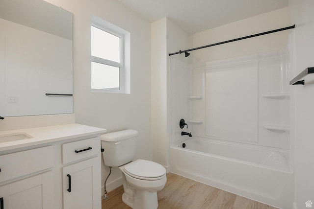full bath featuring wood finished floors, toilet, vanity, and shower / bathtub combination