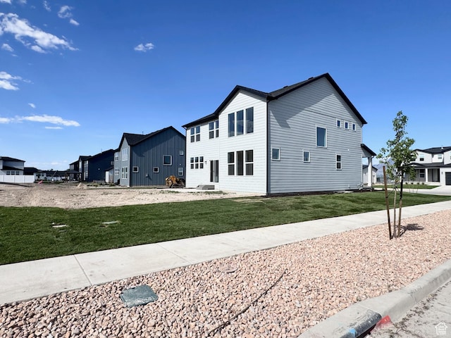 view of property exterior with a yard and a residential view
