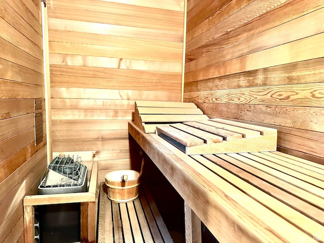 relaxing sauna / steam room featuring wood walls