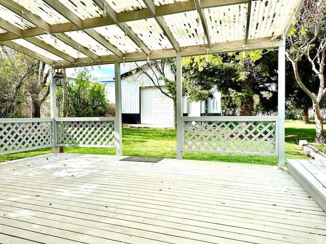 deck with a yard, an outbuilding, and a garage
