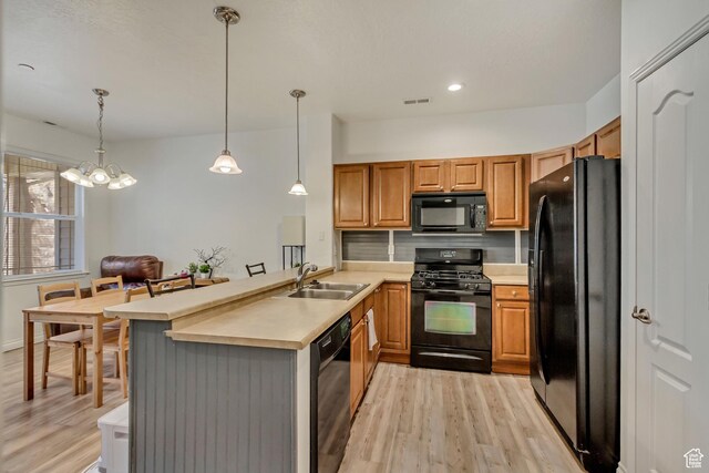 24 S 1520 W, Pleasant Grove, UT 84062 - kitchen with a sink, a peninsula, black appliances, and light wood-style floors