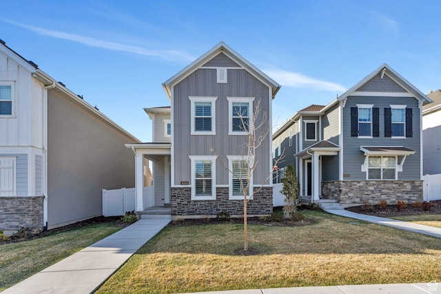 4434 W Glendon Dr, Lehi, UT 84043 - view of front facade featuring board and batten siding, a front yard, and stone siding