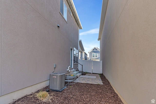 4434 W Glendon Dr, Lehi, UT 84043 - view of side of home with fence, entry steps, stucco siding, and central AC unit