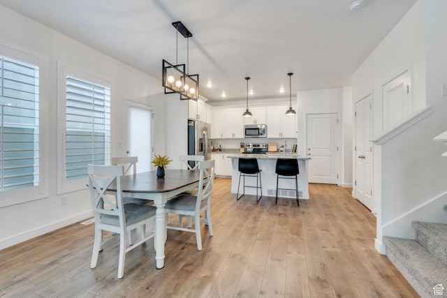 4434 W Glendon Dr, Lehi, UT 84043 - dining area with recessed lighting, baseboards, stairway, and light wood-type flooring