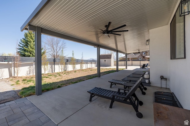 4634 W Baldy Dr, West Jordan, UT 84088 - view of patio / terrace featuring a storage unit, a fenced backyard, ceiling fan, and an outbuilding