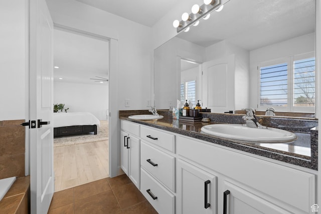 4634 W Baldy Dr, West Jordan, UT 84088 - full bathroom featuring a sink, plenty of natural light, and connected bathroom