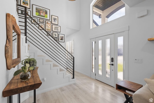 4634 W Baldy Dr, West Jordan, UT 84088 - entrance foyer with stairs, wood finished floors, and a healthy amount of sunlight