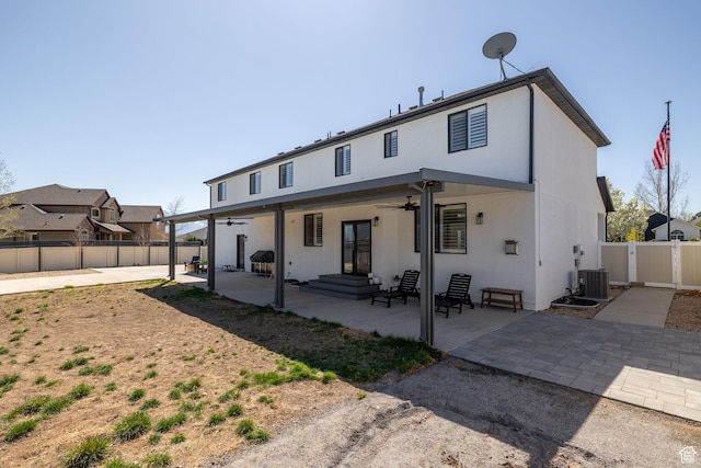 4634 W Baldy Dr, West Jordan, UT 84088 - rear view of house with a patio, a ceiling fan, a fenced backyard, and stucco siding