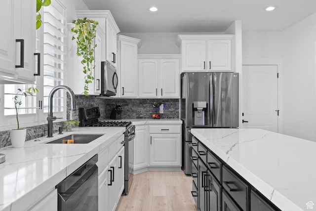 4634 W Baldy Dr, West Jordan, UT 84088 - kitchen with dishwasher, stainless steel refrigerator with ice dispenser, white cabinets, a sink, and black range with gas cooktop