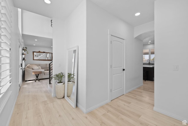 4634 W Baldy Dr, West Jordan, UT 84088 - hallway with light wood-style floors, arched walkways, baseboards, and recessed lighting