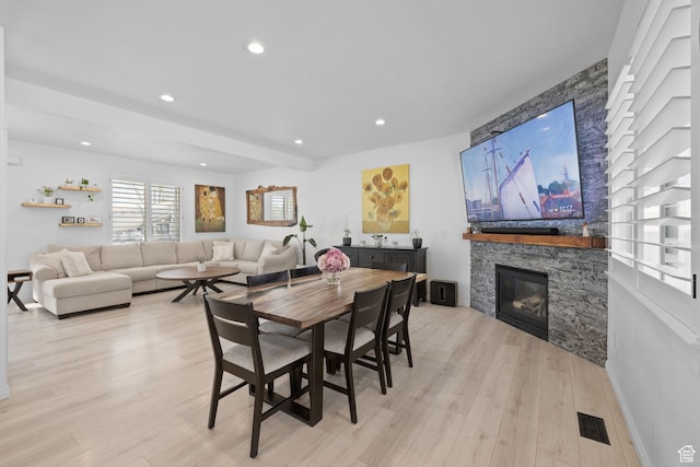 4634 W Baldy Dr, West Jordan, UT 84088 - dining area with a fireplace, recessed lighting, visible vents, and light wood-style floors