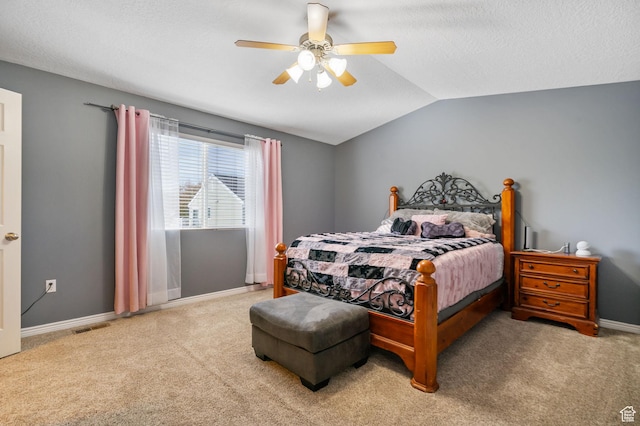 carpeted bedroom featuring ceiling fan, a textured ceiling, visible vents, lofted ceiling, and baseboards