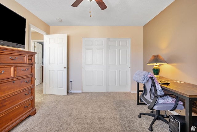 office area with light carpet, baseboards, and a ceiling fan