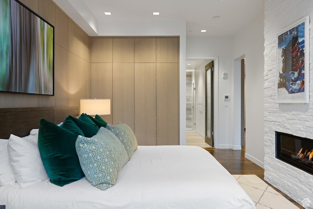 333 Main St Unit 23, Park City, UT 84060 - bedroom featuring wood finished floors, baseboards, and a stone fireplace