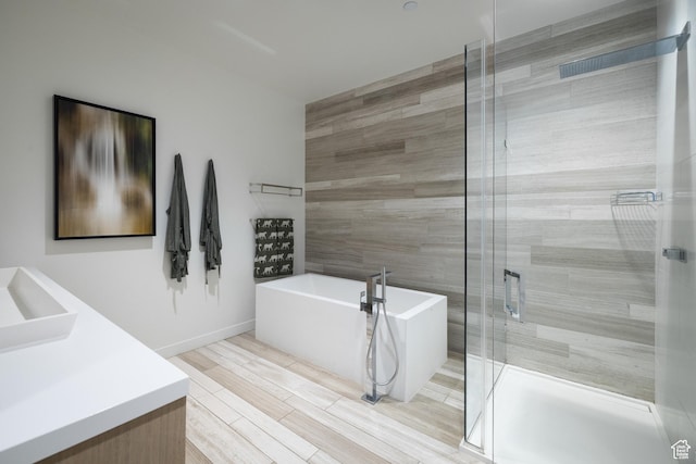 333 Main St Unit 23, Park City, UT 84060 - full bath featuring a freestanding tub, vanity, a stall shower, tile walls, and wood finished floors
