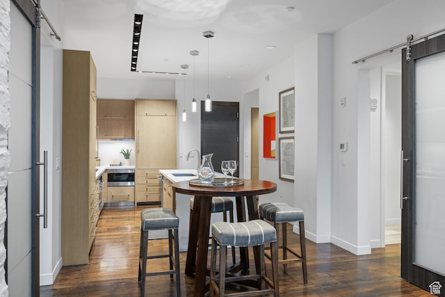 333 Main St Unit 23, Park City, UT 84060 - kitchen with a barn door, dark wood-style flooring, modern cabinets, and a center island with sink