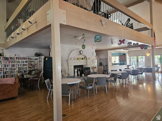 16 Mountain Vw, Hurricane, UT 84737 - dining room featuring wood finished floors, a fireplace, and a high ceiling