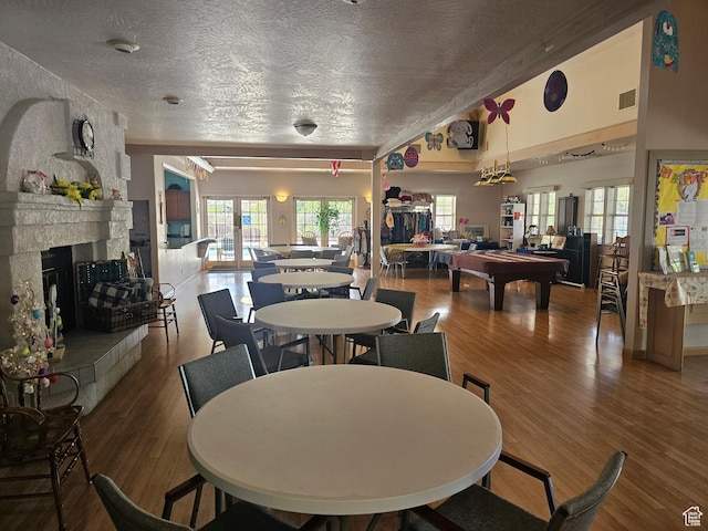 16 Mountain Vw, Hurricane, UT 84737 - dining space with visible vents, a textured ceiling, billiards, wood finished floors, and a large fireplace