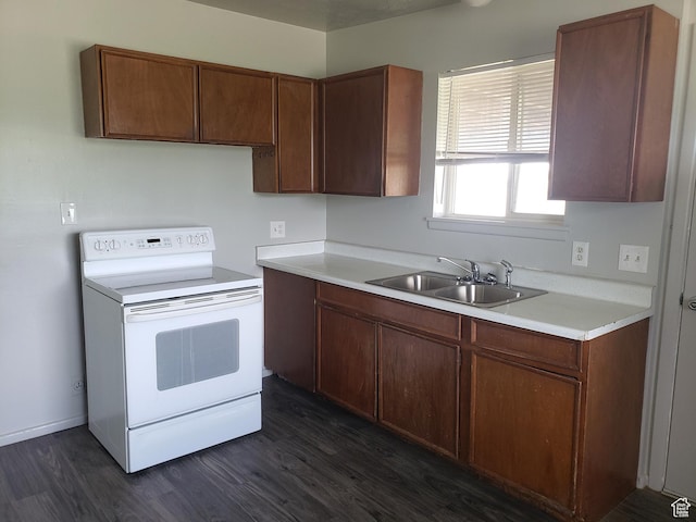 kitchen with light countertops, white electric range, a sink, and dark wood finished floors