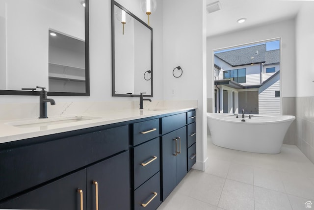4125 N Maple Blvd W Unit 119, Lehi, UT 84043 - bathroom featuring double vanity, a soaking tub, tile patterned floors, and wainscoting