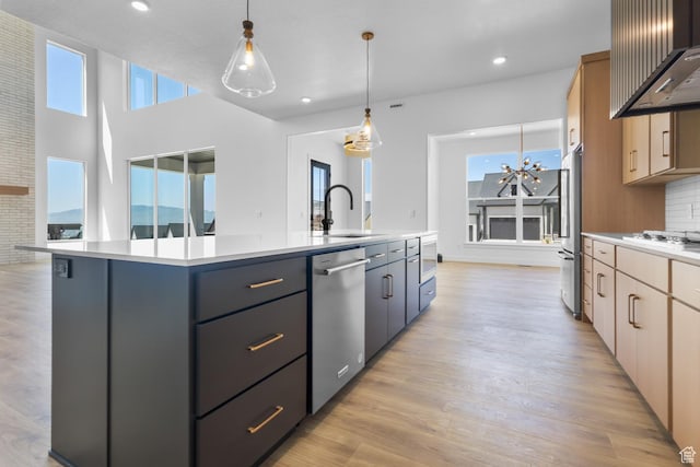 4125 N Maple Blvd W Unit 119, Lehi, UT 84043 - kitchen featuring stainless steel appliances, a sink, wall chimney exhaust hood, a kitchen island with sink, and light countertops
