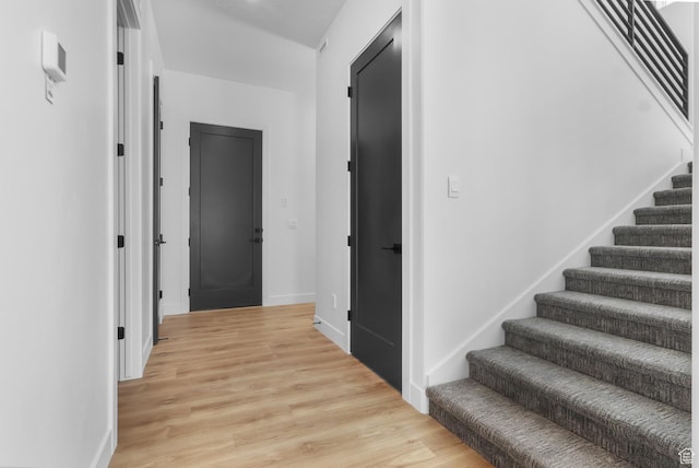 4125 N Maple Blvd W Unit 119, Lehi, UT 84043 - hallway featuring stairway, light wood-type flooring, and baseboards