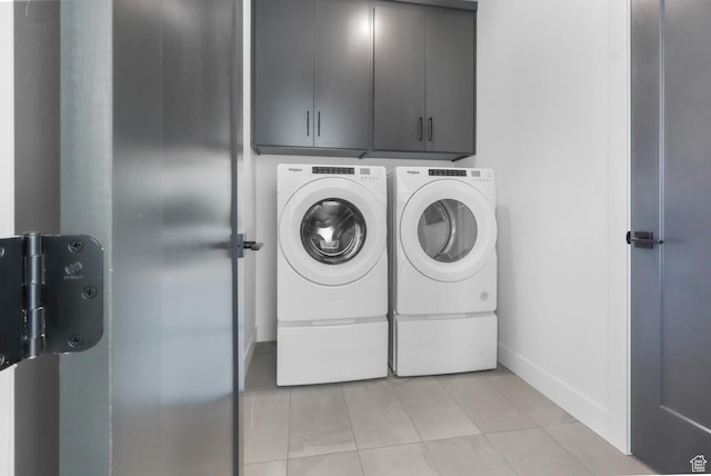 4125 N Maple Blvd W Unit 119, Lehi, UT 84043 - laundry room featuring washing machine and dryer, light tile patterned floors, cabinet space, and baseboards