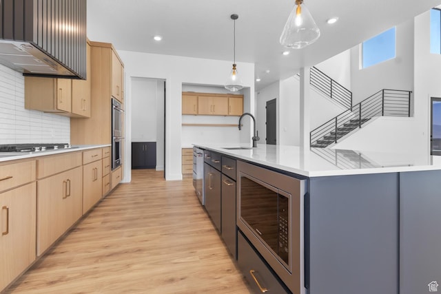 4125 N Maple Blvd W Unit 119, Lehi, UT 84043 - kitchen featuring a sink, light brown cabinets, stainless steel appliances, light countertops, and light wood-style floors