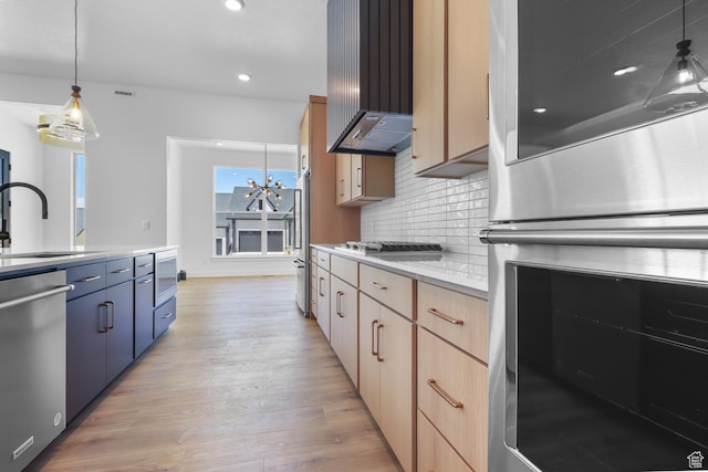 4125 N Maple Blvd W Unit 119, Lehi, UT 84043 - kitchen featuring stainless steel appliances, a sink, light wood finished floors, wall chimney range hood, and tasteful backsplash