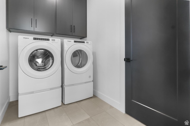 4125 N Maple Blvd W Unit 119, Lehi, UT 84043 - laundry room with washer and clothes dryer, cabinet space, light tile patterned floors, and baseboards