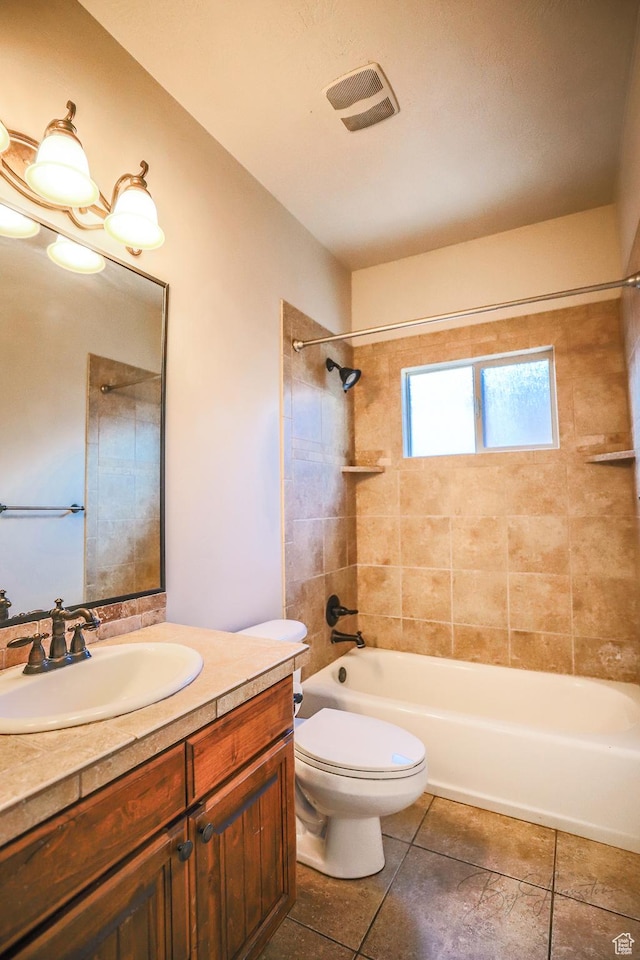 bathroom featuring toilet, shower / bath combination, vanity, and tile patterned floors