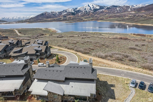 birds eye view of property with a water and mountain view