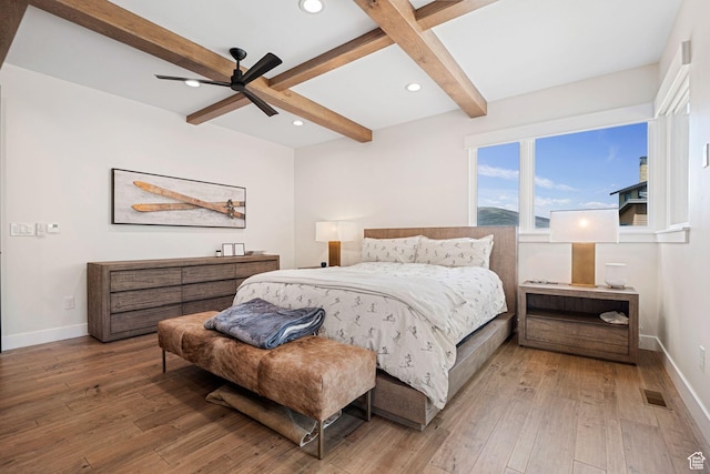 bedroom featuring recessed lighting, hardwood / wood-style floors, baseboards, and beamed ceiling