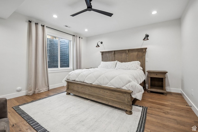 bedroom with recessed lighting, baseboards, and wood finished floors