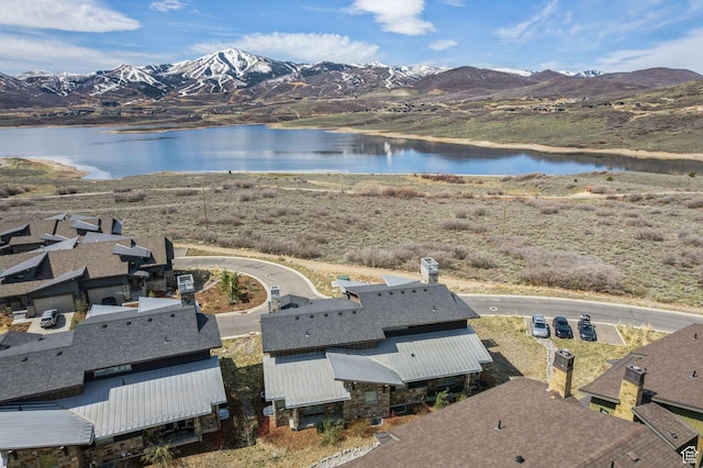 drone / aerial view with a water and mountain view
