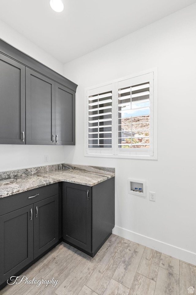 kitchen with light wood-type flooring and baseboards