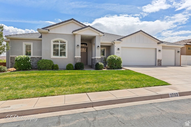 view of front of house featuring driveway, stone siding, an attached garage, a front lawn, and a tile roof