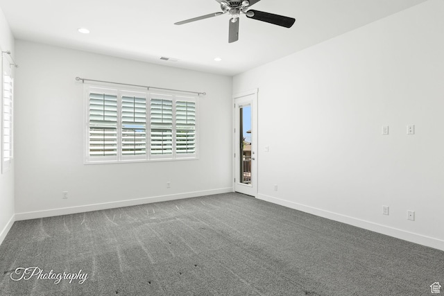spare room featuring visible vents, baseboards, a ceiling fan, and carpet flooring