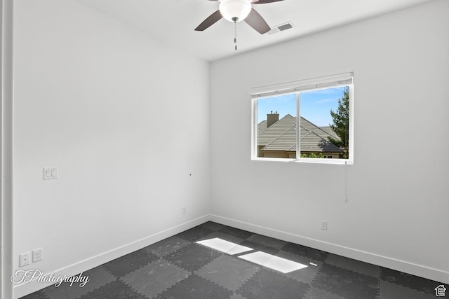 unfurnished room featuring ceiling fan, baseboards, and visible vents
