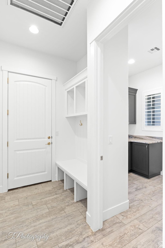 mudroom with recessed lighting, visible vents, and light wood-style flooring